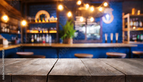 empty wooden table and blurred background of bar or pub for product display