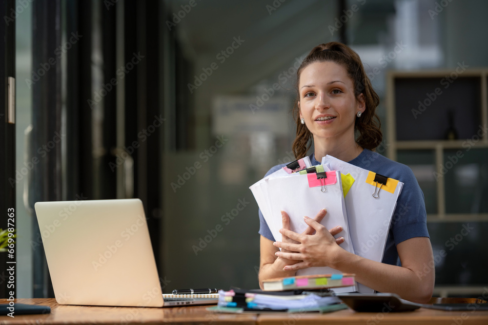 Businesswoman working hard with a lot of documents, searching and checking information Businesswoman working hard with a lot of documents, searching and checking information