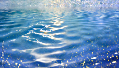 blue water with ripples on the surface defocus blurred transparent blue colored clear calm water surface with splashes and bubbles water waves with shining pattern background