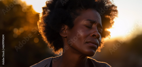 Close up lifestyle portrait of exhausted and stressed middle aged black woman standing outside