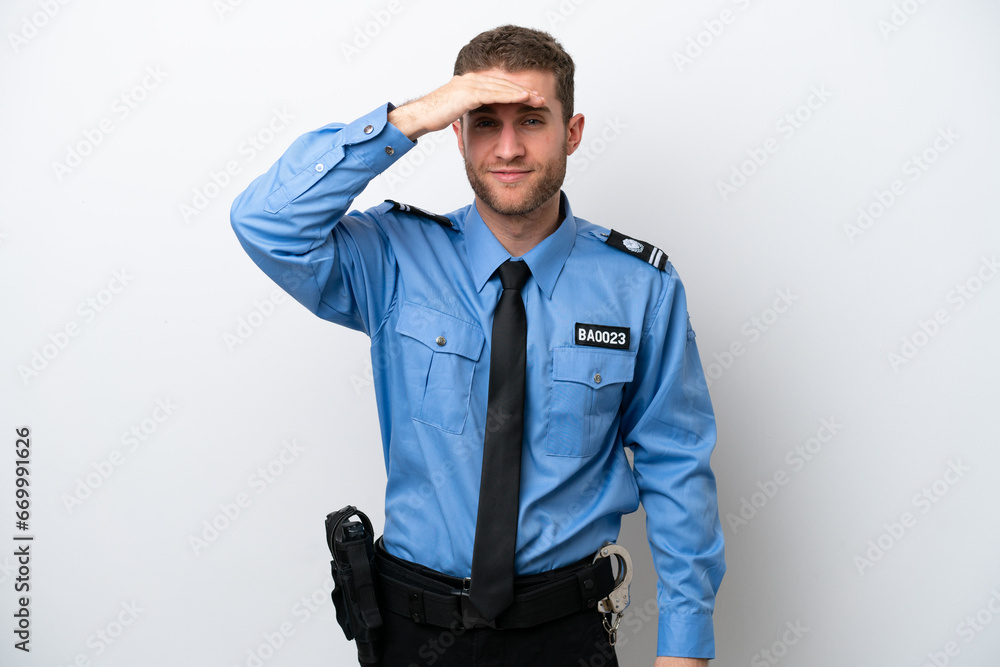 Young police caucasian man isolated on white background looking far away with hand to look something Young police caucasian man isolated on white background looking far away with hand to look something