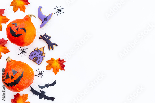 Frame of orange Halloween pumpkins and funny cookies  top view