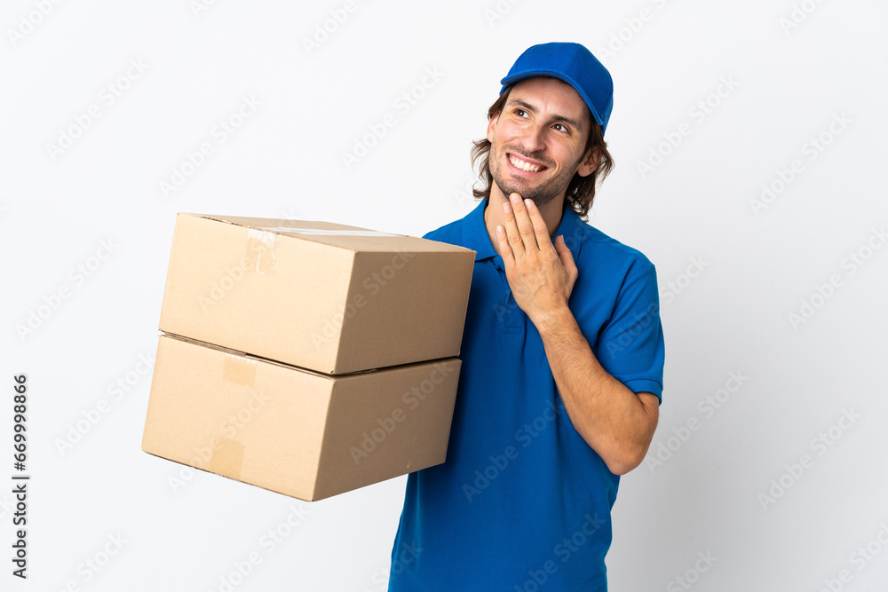 Delivery man isolated on white background looking up while smiling Delivery man isolated on white background looking up while smiling