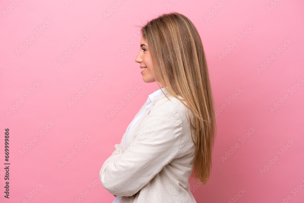 Young caucasian woman isolated on pink bakcground in lateral position Young caucasian woman isolated on pink bakcground in lateral position