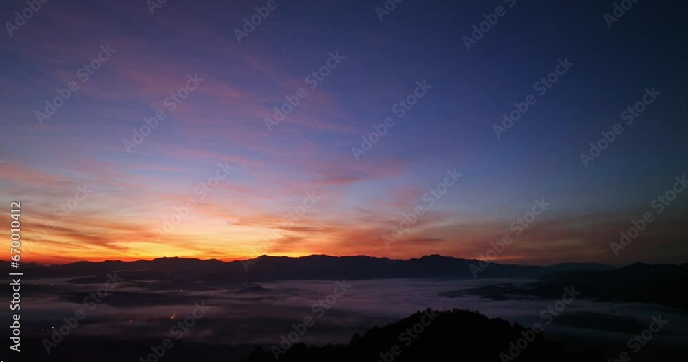 ..aerial view The golden yellow sun was setting on the horizon..the brightly colored sky at sunset..mist floating in the valley in sunset. ..aerial view The golden yellow sun was setting on the horizon..the brightly colored sky at sunset..mist floating in the valley in sunset.