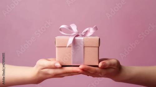 close up of someone holding a gift box tied with a bow © Thuch