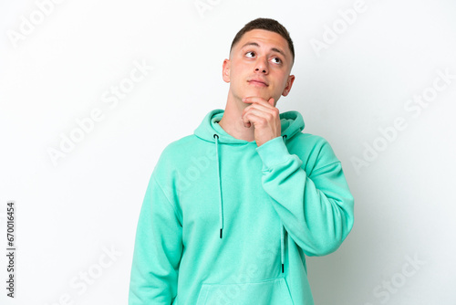Young brazilian man isolated on white background having doubts