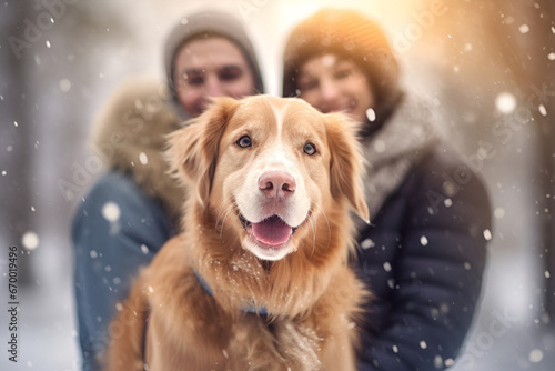 A couple in love with a dog on the background of a winter snowy forest