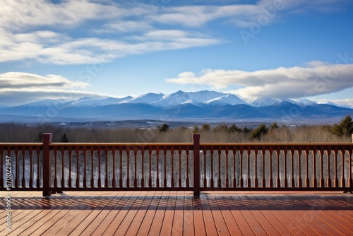 a deck with carved railings and a panoramic mountain view © studioworkstock