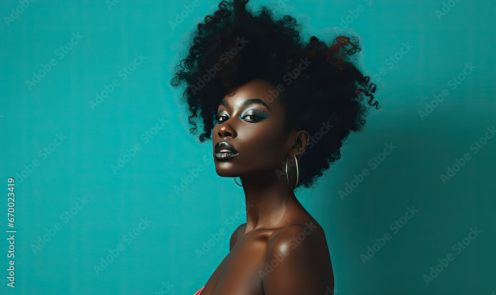 Confident black woman with afro against vibrant turquoise wall. Confident black woman with afro against vibrant turquoise wall.