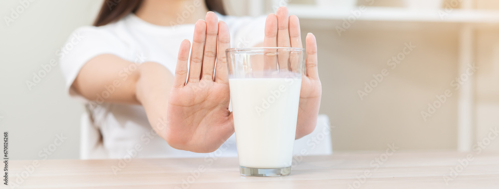 Allergy asian young woman, girl hand in deny, no or push out to avoid for drink milk at home, unhappy and bad stomach ache. Lactose intolerance and dairy food, health problem, belly suffer concept. Allergy asian young woman, girl hand in deny, no or push out to avoid for drink milk at home, unhappy and bad stomach ache. Lactose intolerance and dairy food, health problem, belly suffer concept.