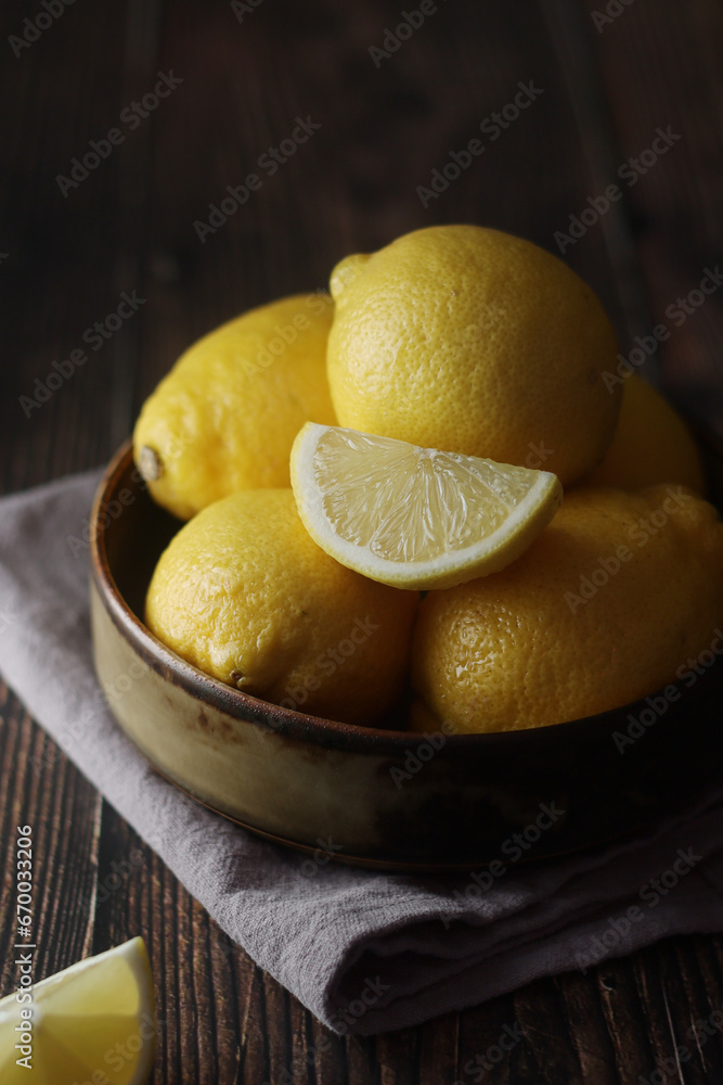A bowl with yellow bright lemons	