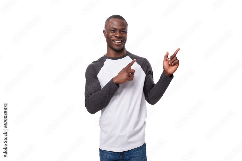 young american man dressed casually pointing with his hands at the advertising space young american man dressed casually pointing with his hands at the advertising space