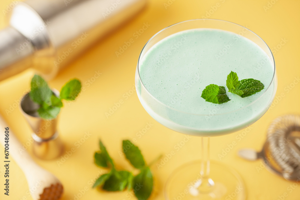 Grasshopper cocktail from New Orleans, with green mint liqueur, chocolate liqueur and cream in cocktail glass. Grasshopper cocktail from New Orleans, with green mint liqueur, chocolate liqueur and cream in cocktail glass.