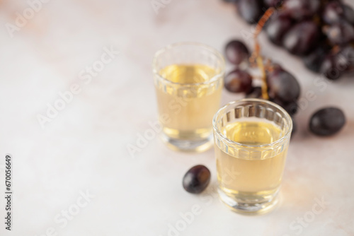 Traditional Georgian chacha, also known as grape vodka or Georgian grappa in shot glasses and fresh grapes