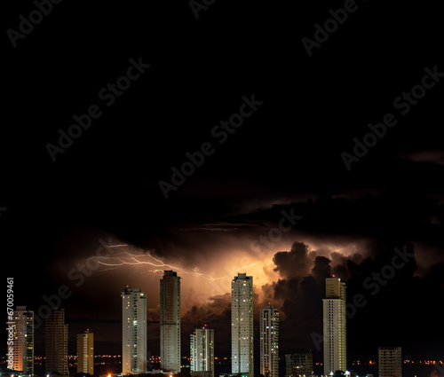 Dazzling stormy night over urban skyline with skyscrapers