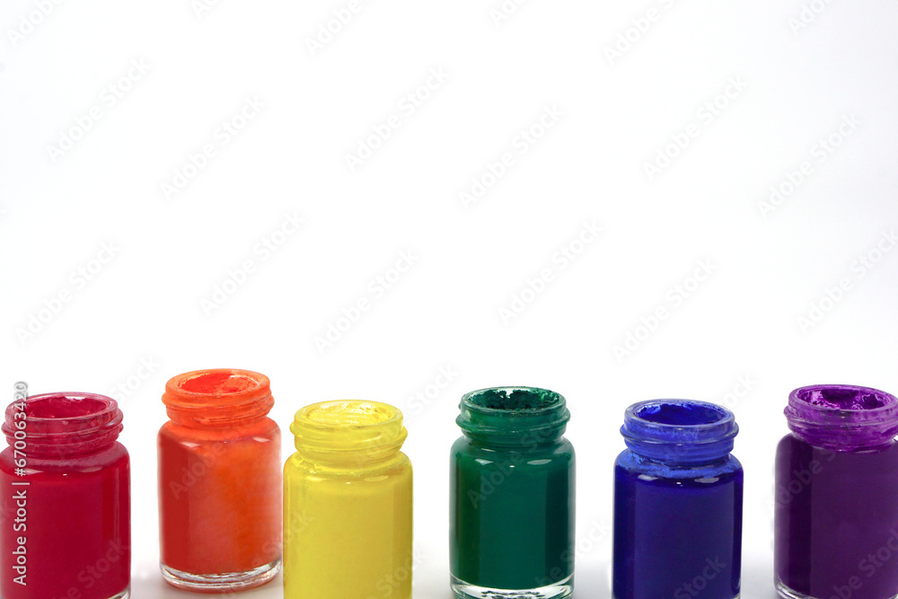 Watercolor bottles lined up on a white background. Learning and paintings art concept. Watercolor bottles lined up on a white background. Learning and paintings art concept.