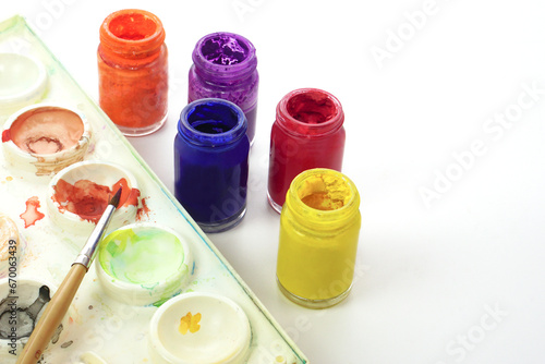 Watercolor tray, paintbrush and watercolor bottleson white background. Learning and paintings art concept.