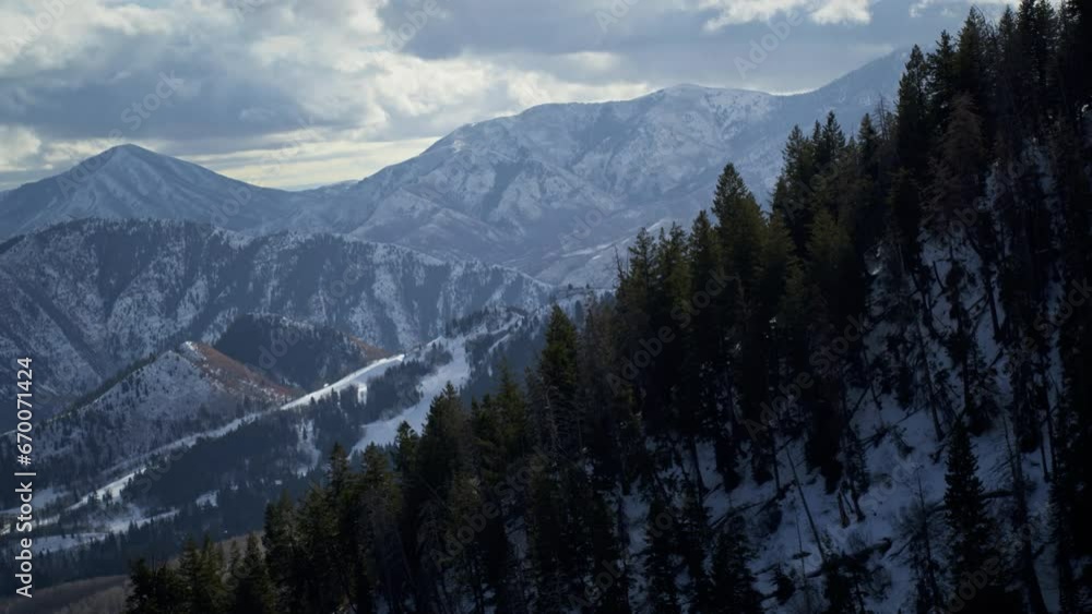 Cinematic drone shot high above winter rocky mountains Cinematic drone shot high above winter rocky mountains