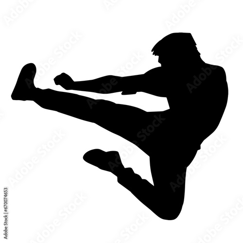 Silhouette of a muscular man of martial art fighter doing flying kick pose.