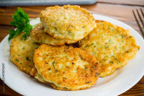 cooked fried potato cutlets with herbs photo