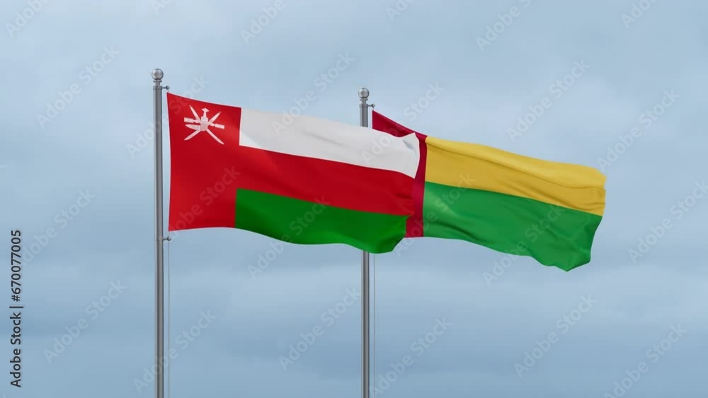 Guinea-Bissau flag and Oman flag waving together on cloudy sky, endless seamless loop, two country relations concept Guinea-Bissau flag and Oman flag waving together on cloudy sky, endless seamless loop, two country relations concept