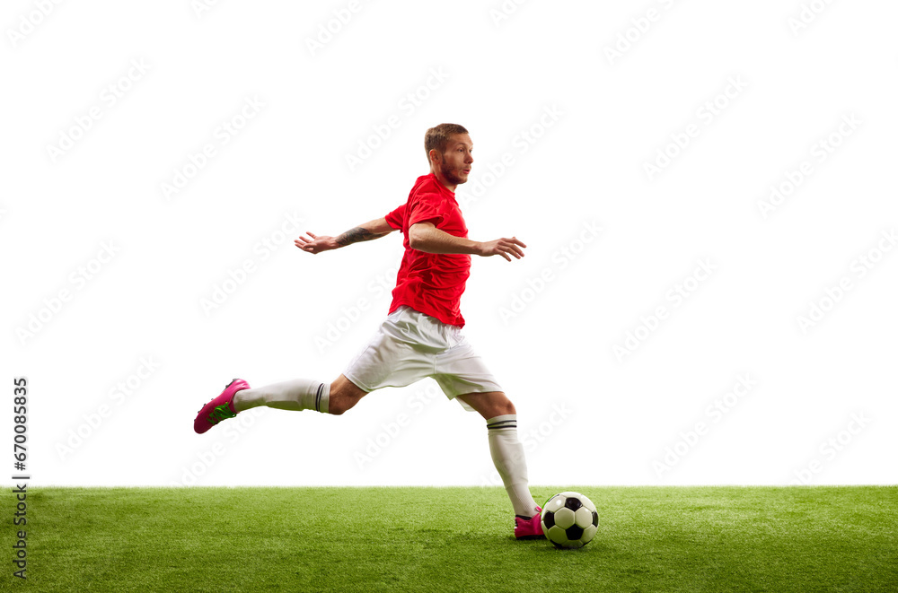 Full length portrait of professional soccer player contemplating perfect kicking of ball. Footballer's focus, unwavering and determined.