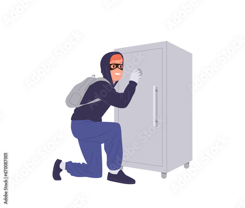 Thief tries to break into bank safe picking up security code to steal money or jewelry isolated
