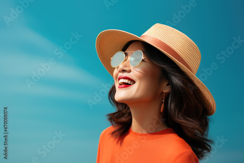  beautiful young cheerful girl wearing glasses and hat rests at morning beach