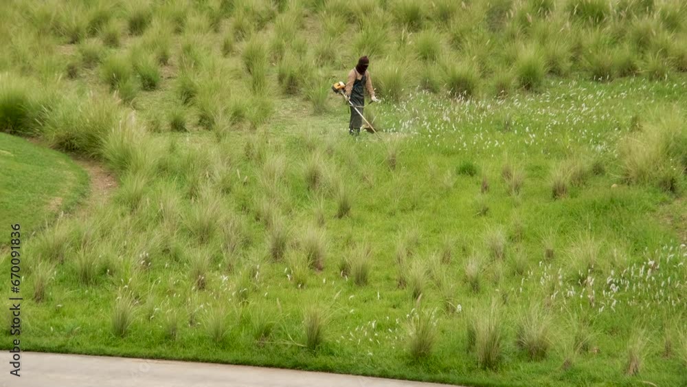 Workers are cutting grass on a golf course. Workers are cutting grass on a golf course.