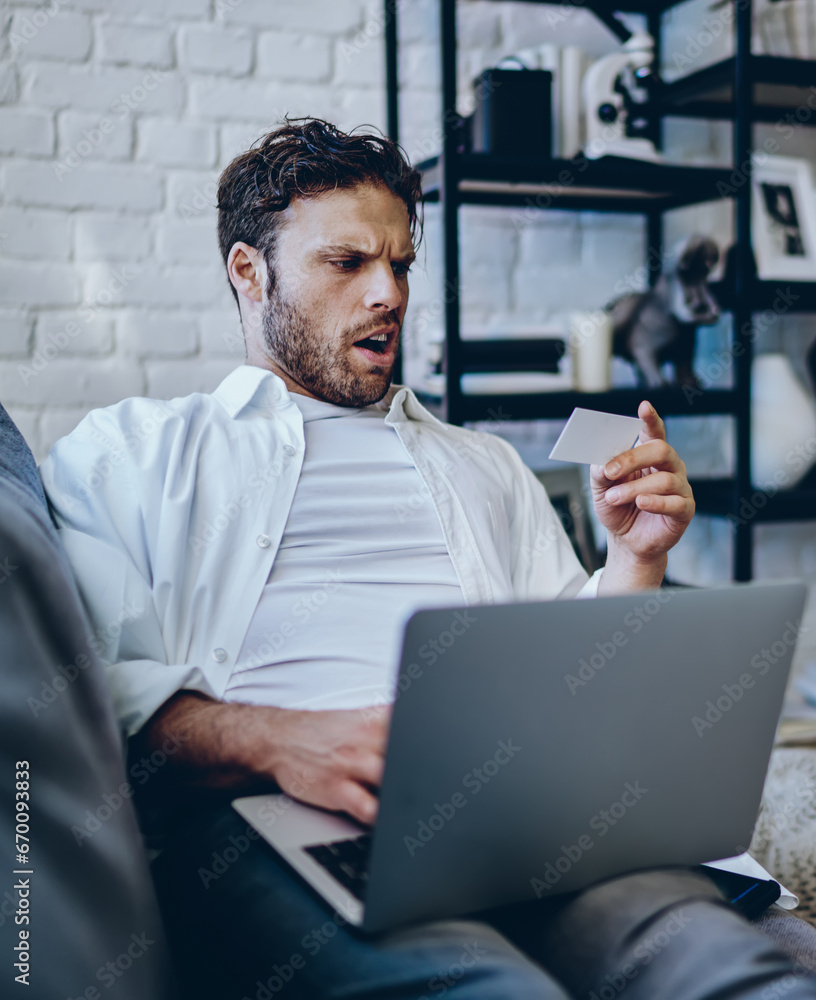 surprised hipster guy amazed from reading name on business card surprised hipster guy amazed from reading name on business card