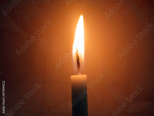 Veiw of one candle light blurred background for design stock photo, candle flame burning photo