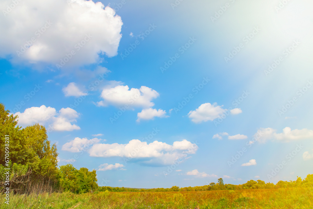 Sky with clouds over a summer field. Country landscape without people with empty space for text.
