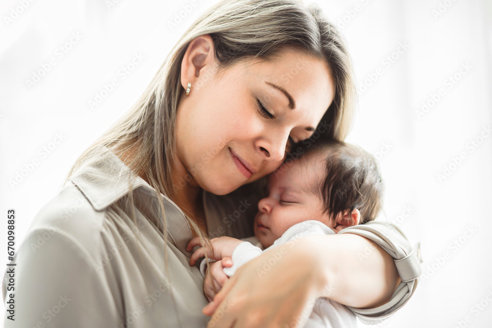 Mother on bedroom with his newborn baby son Mother on bedroom with his newborn baby son