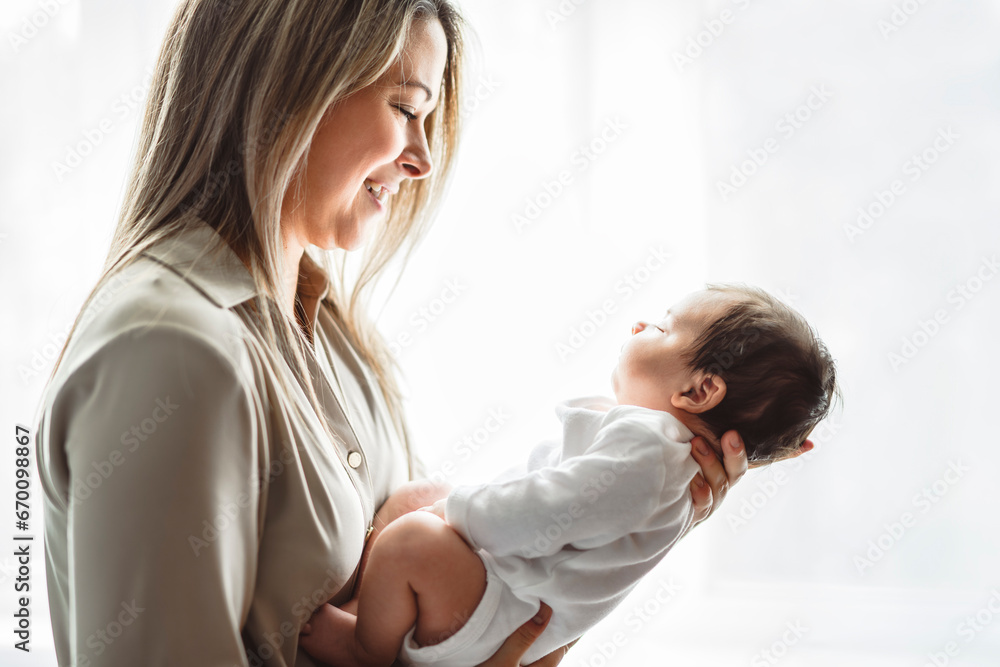 Fototapeta premium Mother on bedroom with his newborn baby son