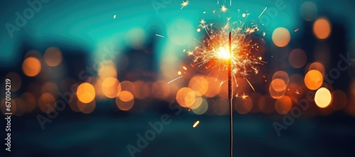 A close-up of a Bengal light on a urban blurred background. Celebration of the new year and Christmas. Party accessory