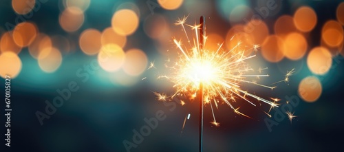 A close-up of a Bengal light on a urban blurred background. Celebration of the new year and Christmas. Party accessory