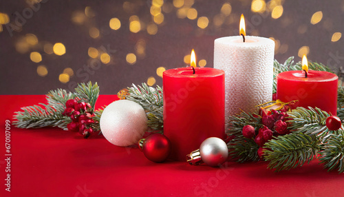 Burning candle with christmas decoration and red background
