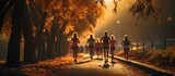 a group of healthy young people running on an urban trail in the morning. jogging on the park path, focus on the legs.