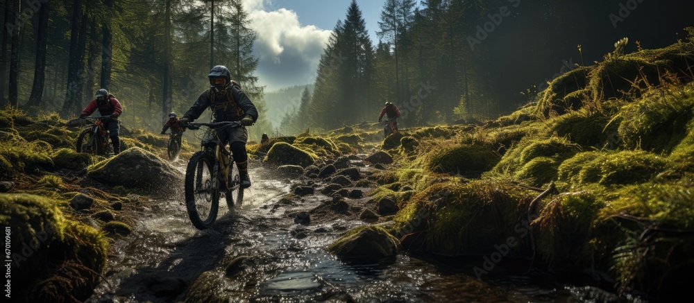 A group of mountain bikers, they cycle through mountain roads in the middle of the forest.
