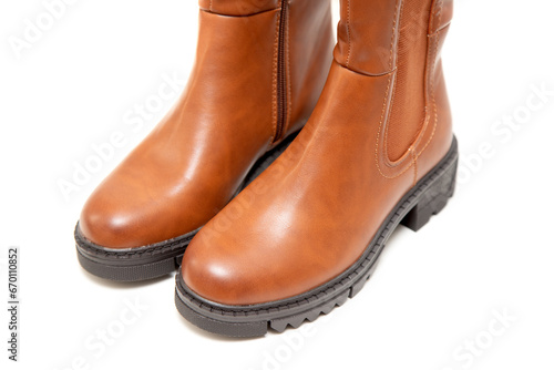 New high brown boots on a white background.