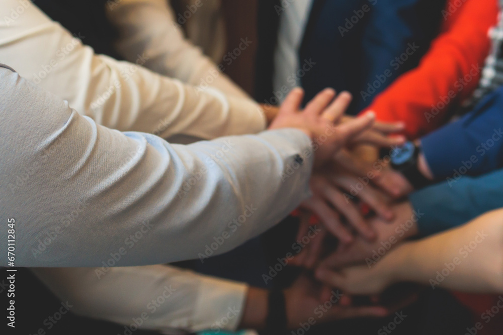 Group team of young people stacking hands together during contest competition, corporate business teamwork and support, coworkers and colleagues, team members hands of partners stacked for success