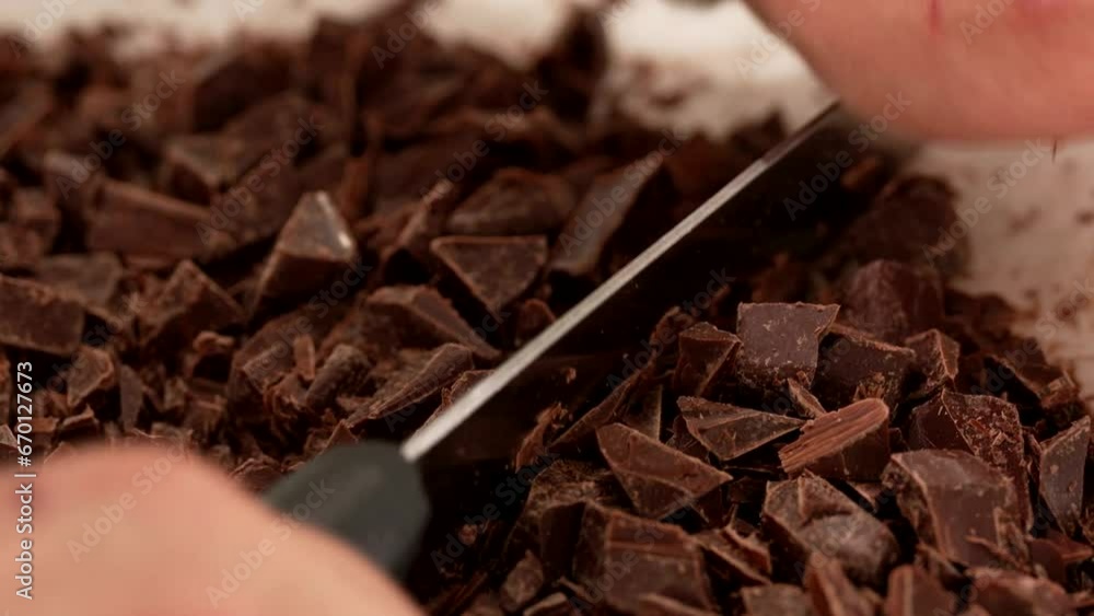chef chops chocolate with knife
chef chops chocolate with knife