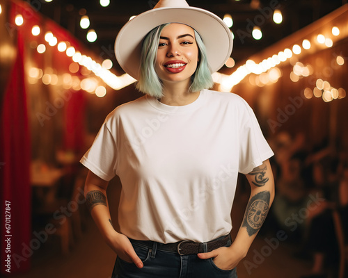 tshirt mock up cowgirl:: A curvy hipster alternative woman with tattoos, green hair wears a cowboy hat in a saloon bar. A blank white t shirt mockup. Disco cowgirl bachelorette aesthetic photo