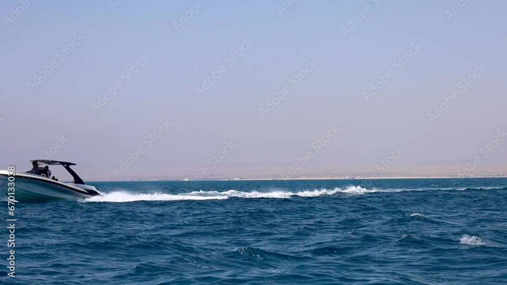 Speed boat passing by a moving tourist boat in the Red Sea Speed boat passing by a moving tourist boat in the Red Sea
