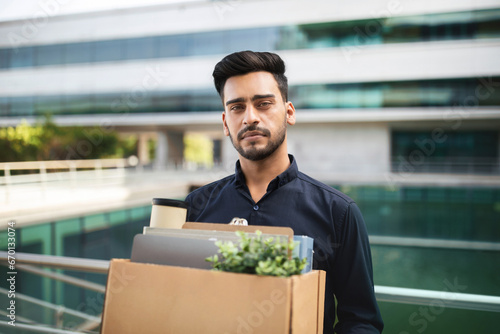 Jobless Arabian man with his belongings in carton box outdoor