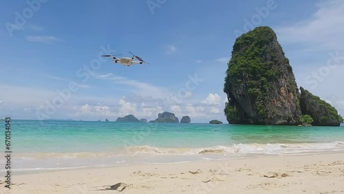 Video of a drone flying on a beautiful sandy beach with an emerald sea photo