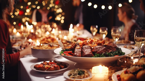 Luxury christmas dinner table, people are gathered and enjoy full of dishes, snacks and wine glasses photo
