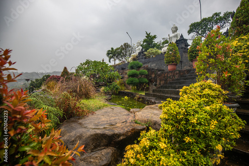 A Buddhist temple in the evening in the rain. The Brahmavihara-Arama temple has beautiful gardens and also houses a monastery. Tropical plants near Banjar, Bali photo