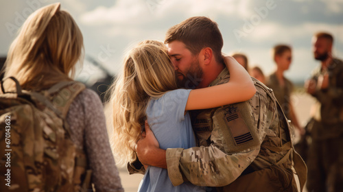 Happy army soldier finally meeting his wife or girlfriend wearing military uniform with chevrons, family hugging in crowd of people